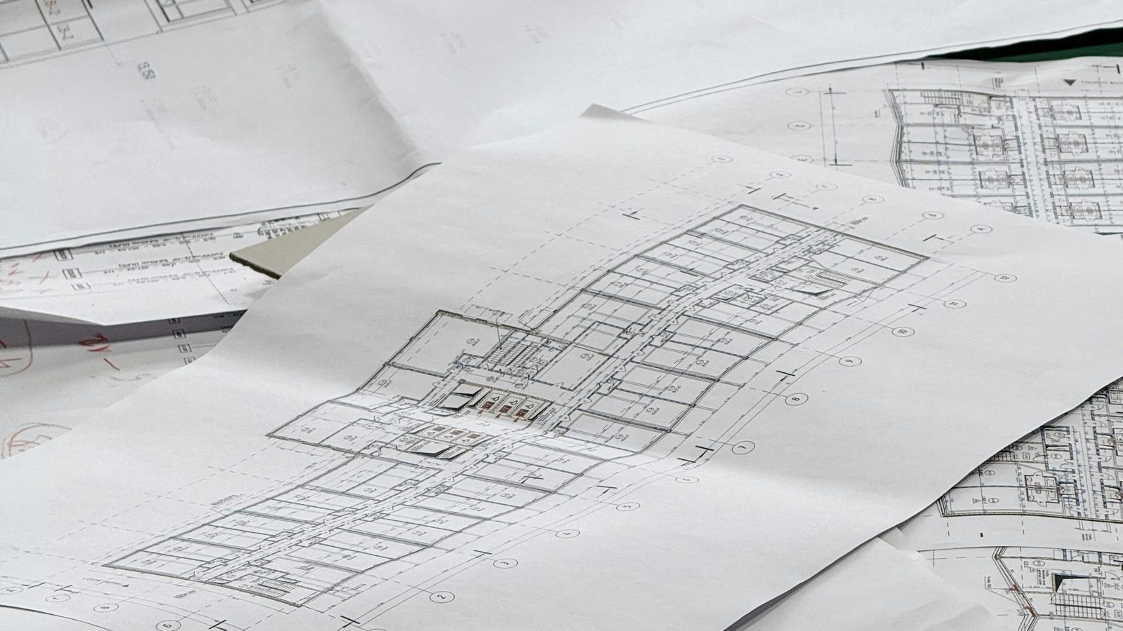 Architectural floor plans spread across a table