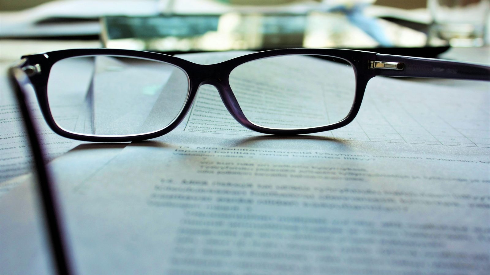Reading glasses resting on a printed document